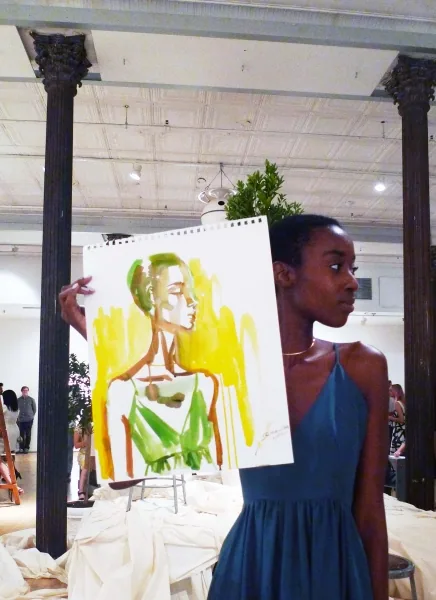 Live painting event, a guest with their finished portrait, illustration by Samantha Hahn